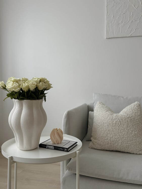 Free Photo Of Porcelain Vase Full Of Roses On A Coffee Table Next To A White Couch